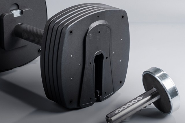 Close-up of the 100lb black adjustable dumbbell's weight plates.