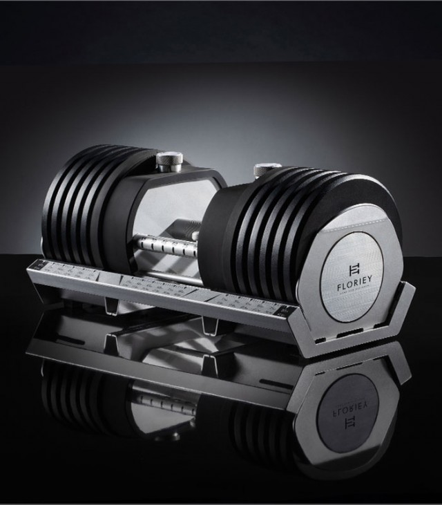 100lb black adjustable dumbbell set on a sleek platform.