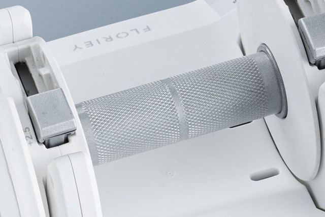 Handle of white 12.5lb adjustable dumbbell with textured grip