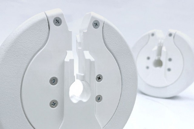 Close-up of white weight plates for adjustable dumbbells, highlighting the locking mechanism