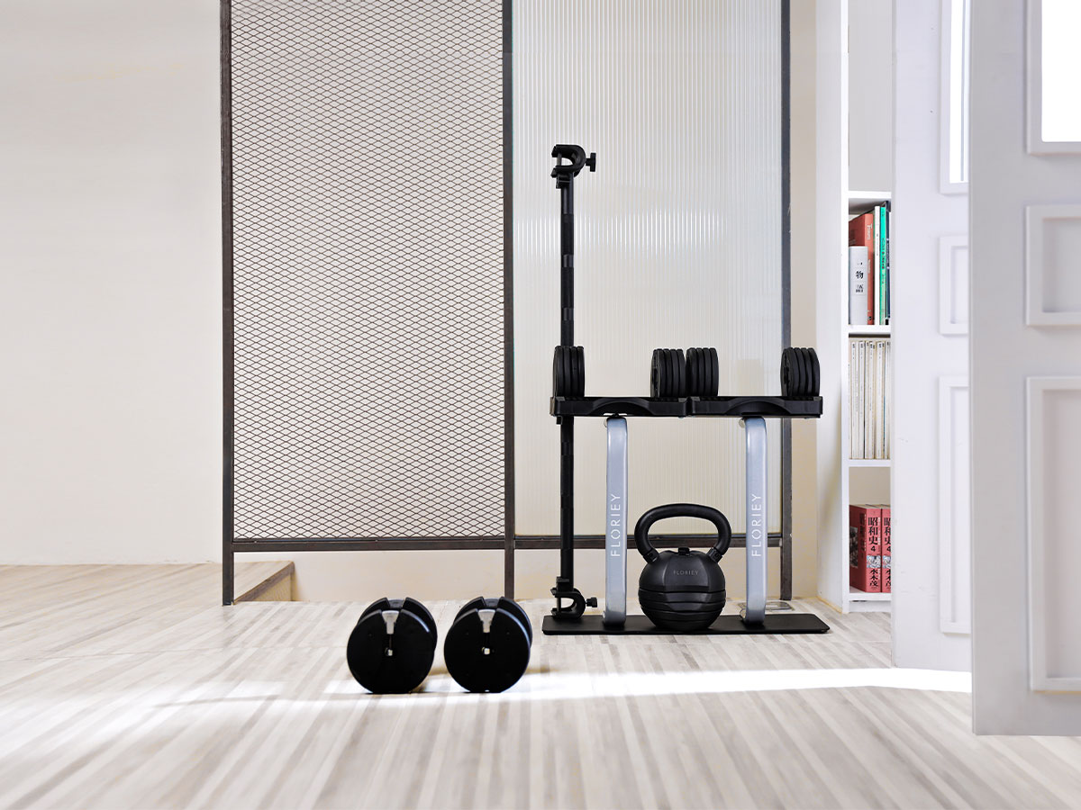 Home gym setup with 12.5lb adjustable dumbbell and other gym accessories