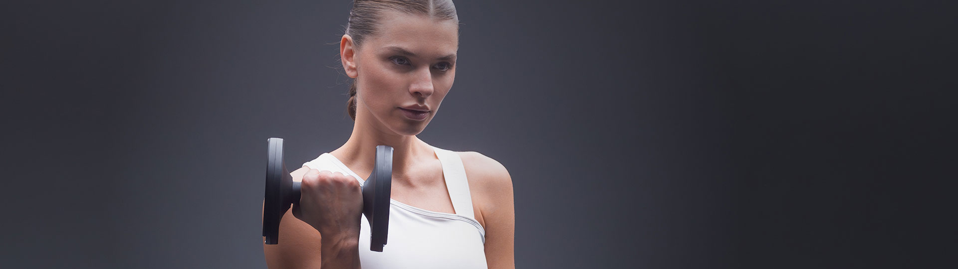 Woman performing bicep curl with a 25lb black adjustable dumbbell