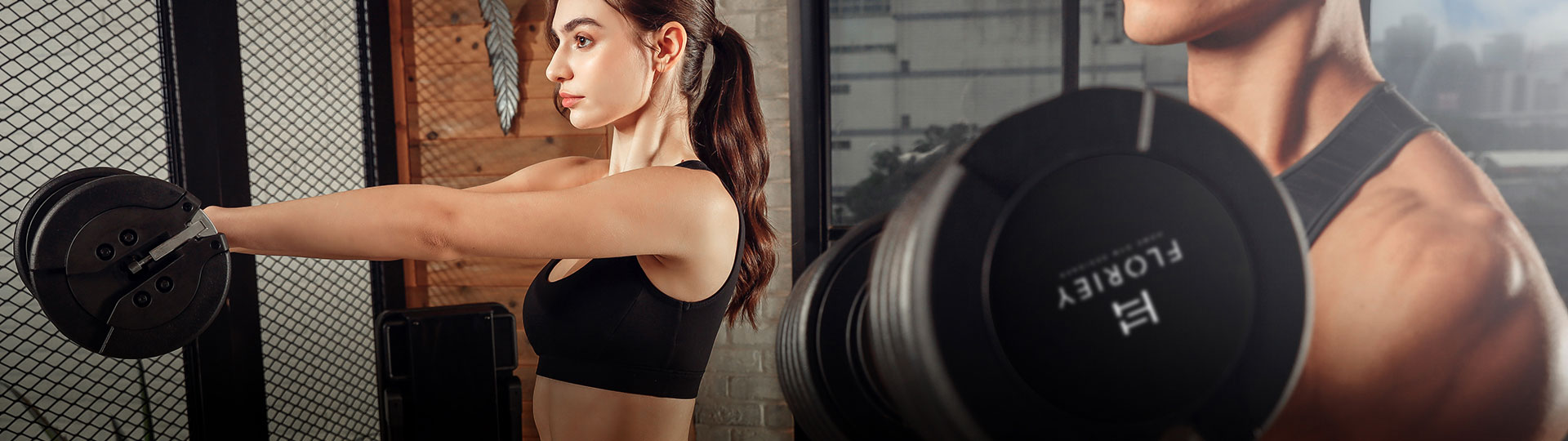Woman performing weight training with 50lb black adjustable dumbbells from T9 series
