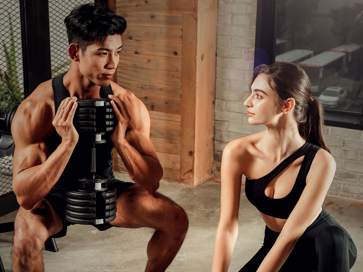 A man and woman working out with T9 series black dumbbells by Floriey.