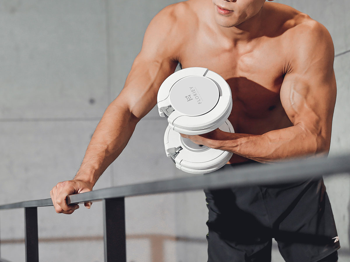 Man exercising with the Floriey T9 Series 50 lb White Adjustable Dumbbell.
