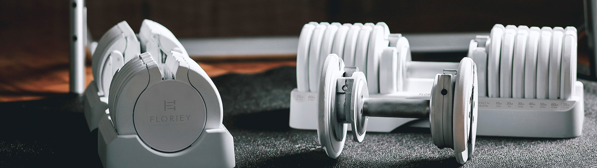 75 lb adjustable dumbbells in a gym setting